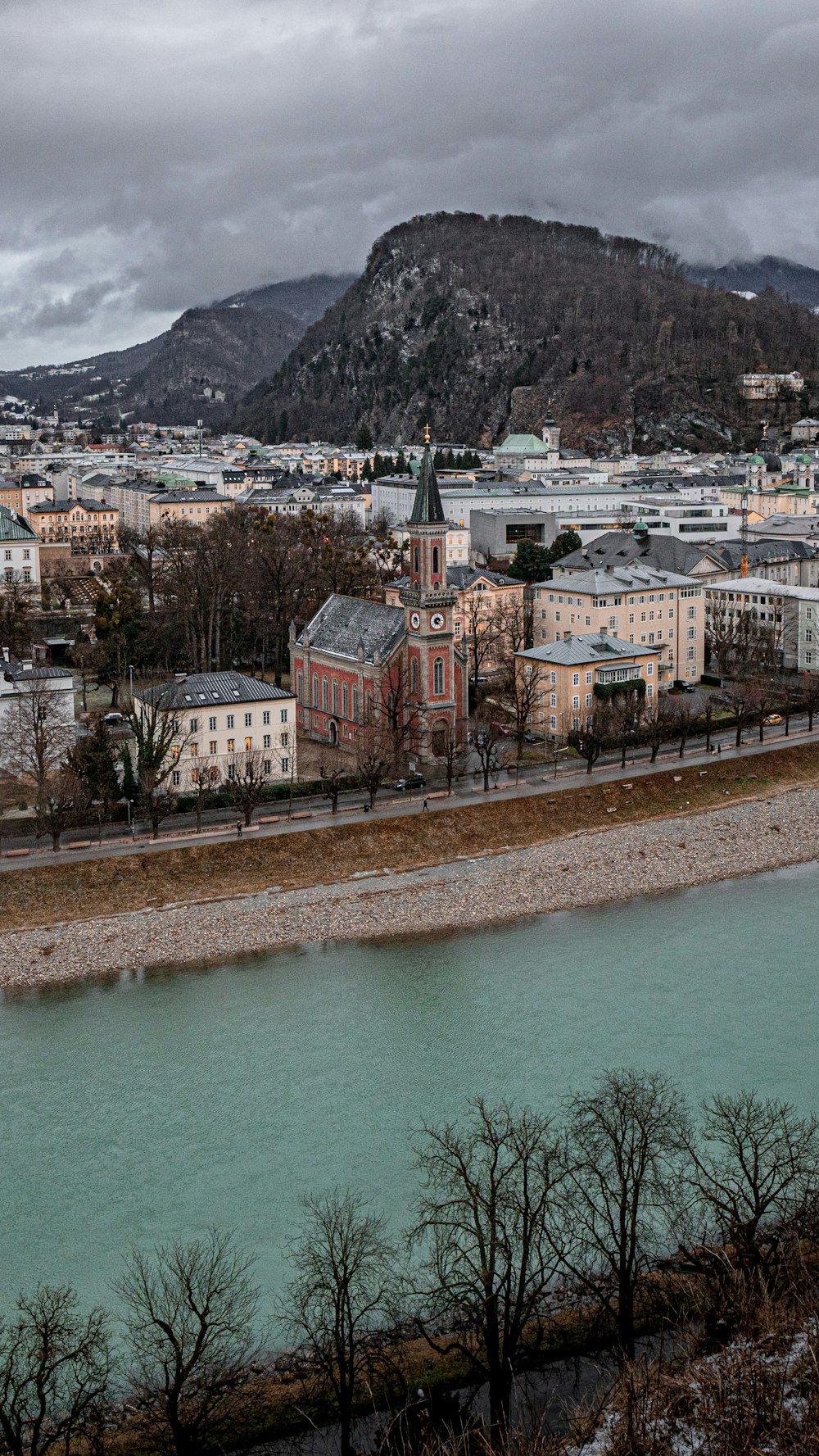 a river running through a city next to a mountain