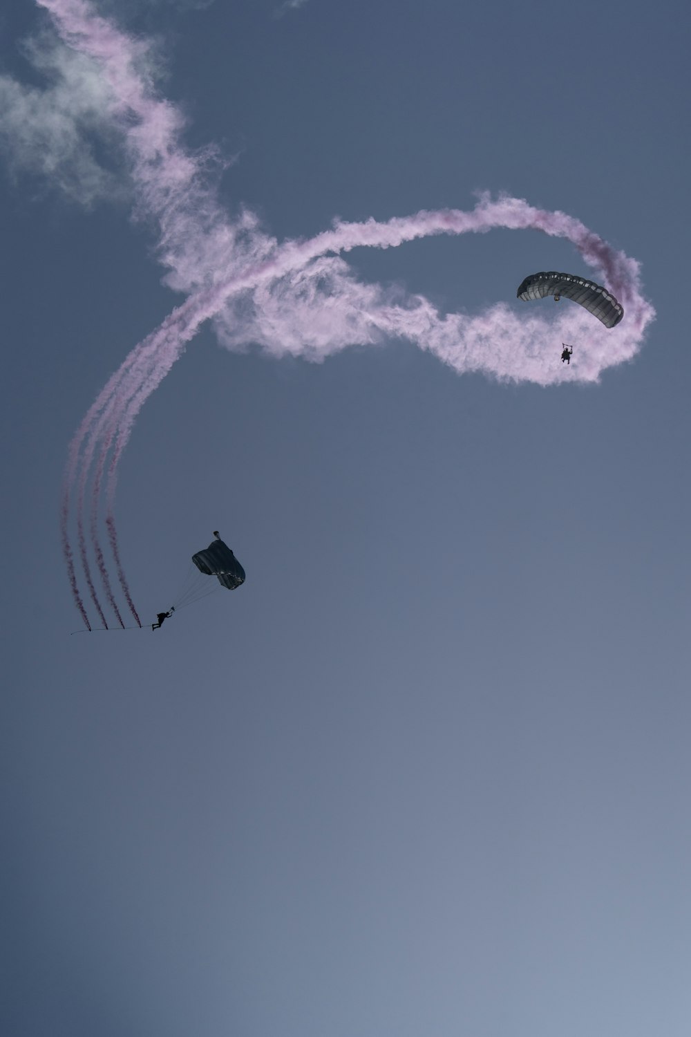 a group of people flying kites in the sky