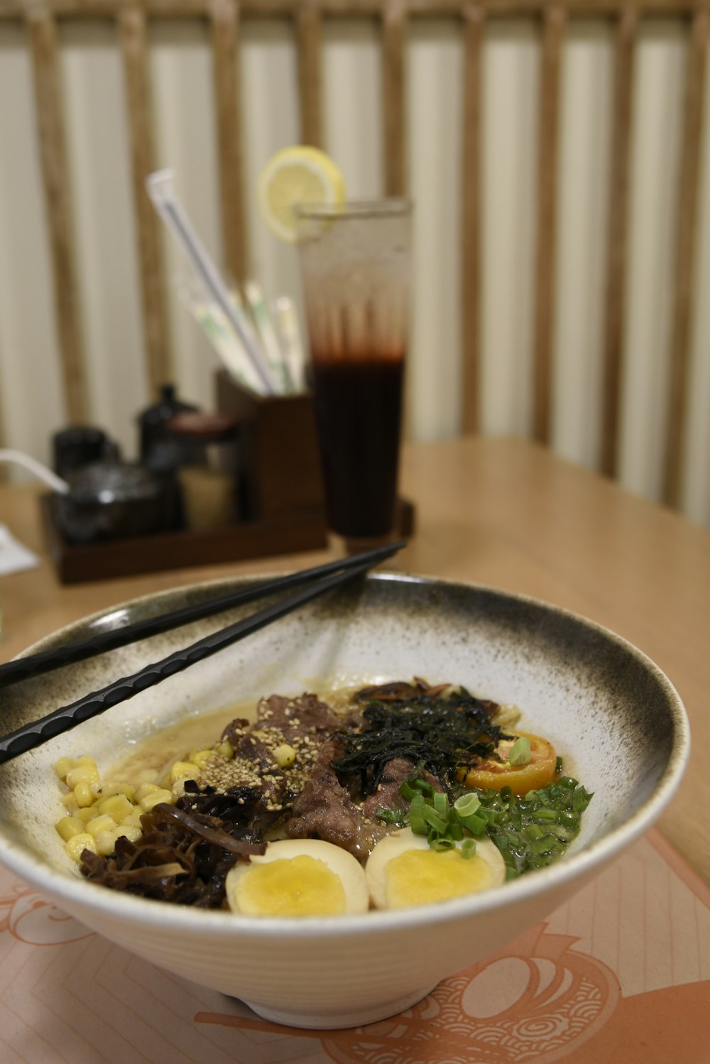 a bowl of food with chopsticks on a table