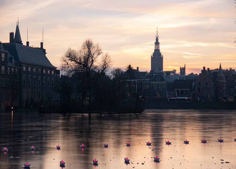 a body of water surrounded by buildings and a clock tower