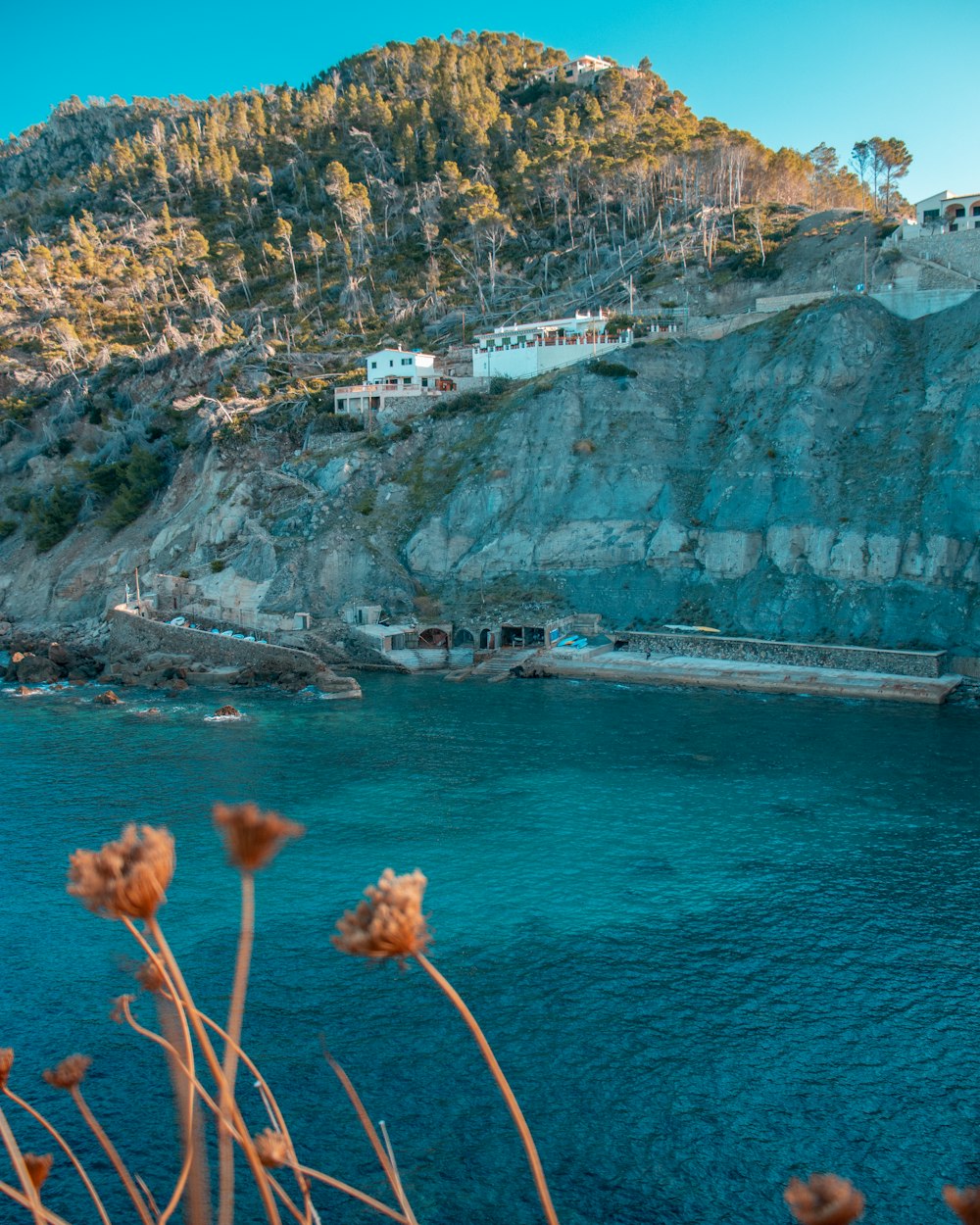 a body of water with a hill in the background