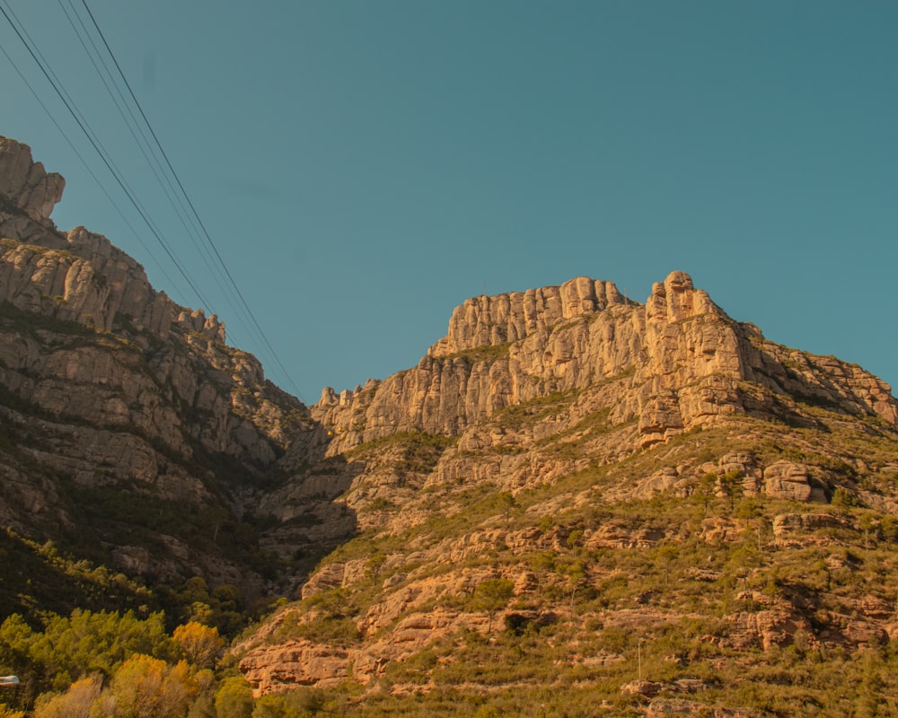 a view of a mountain with a power line above it