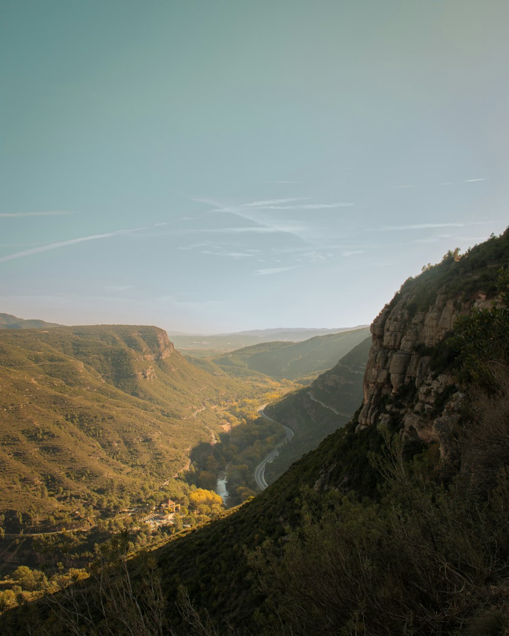 a view of a valley with a river running through it