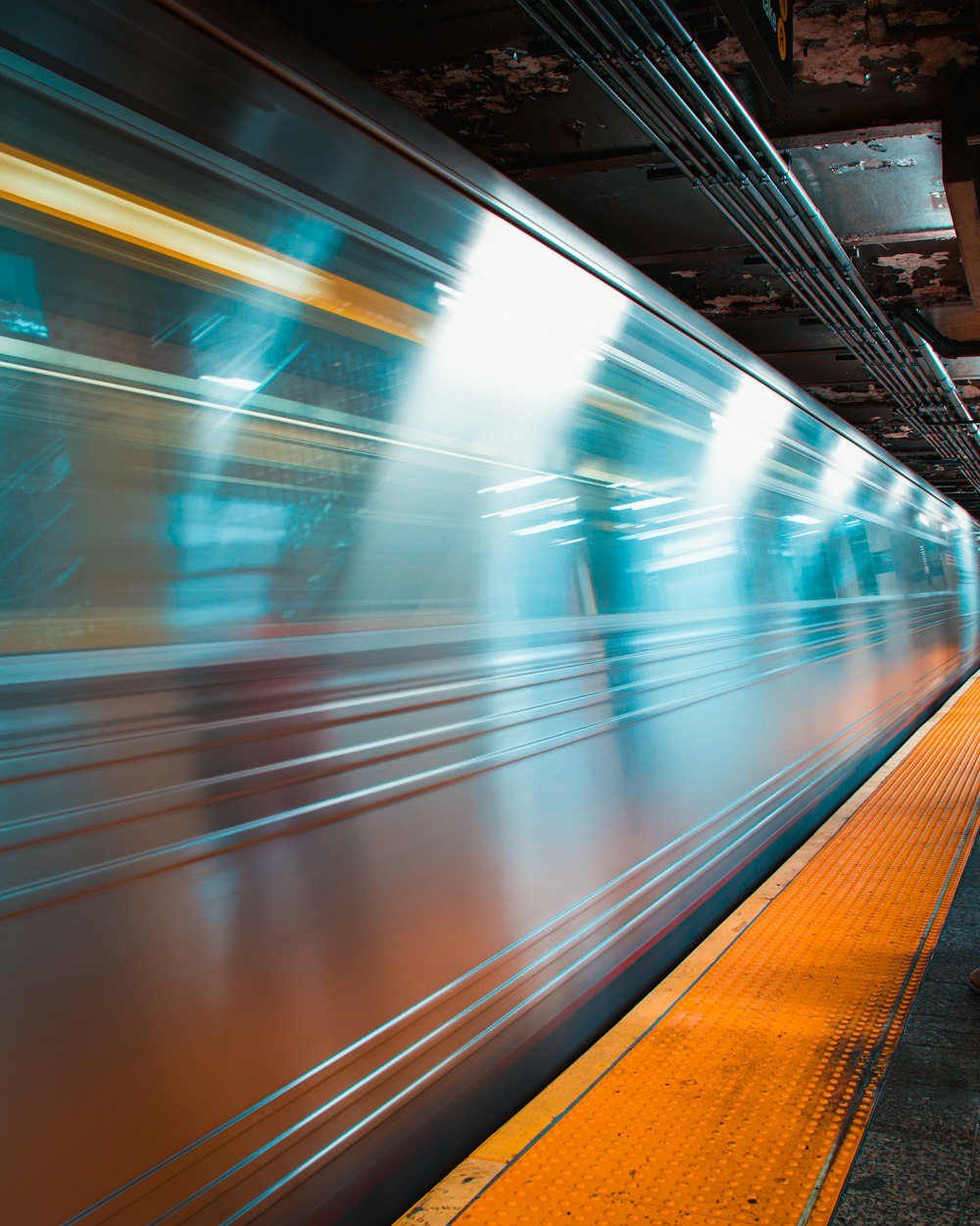 a blurry photo of a train moving through a station