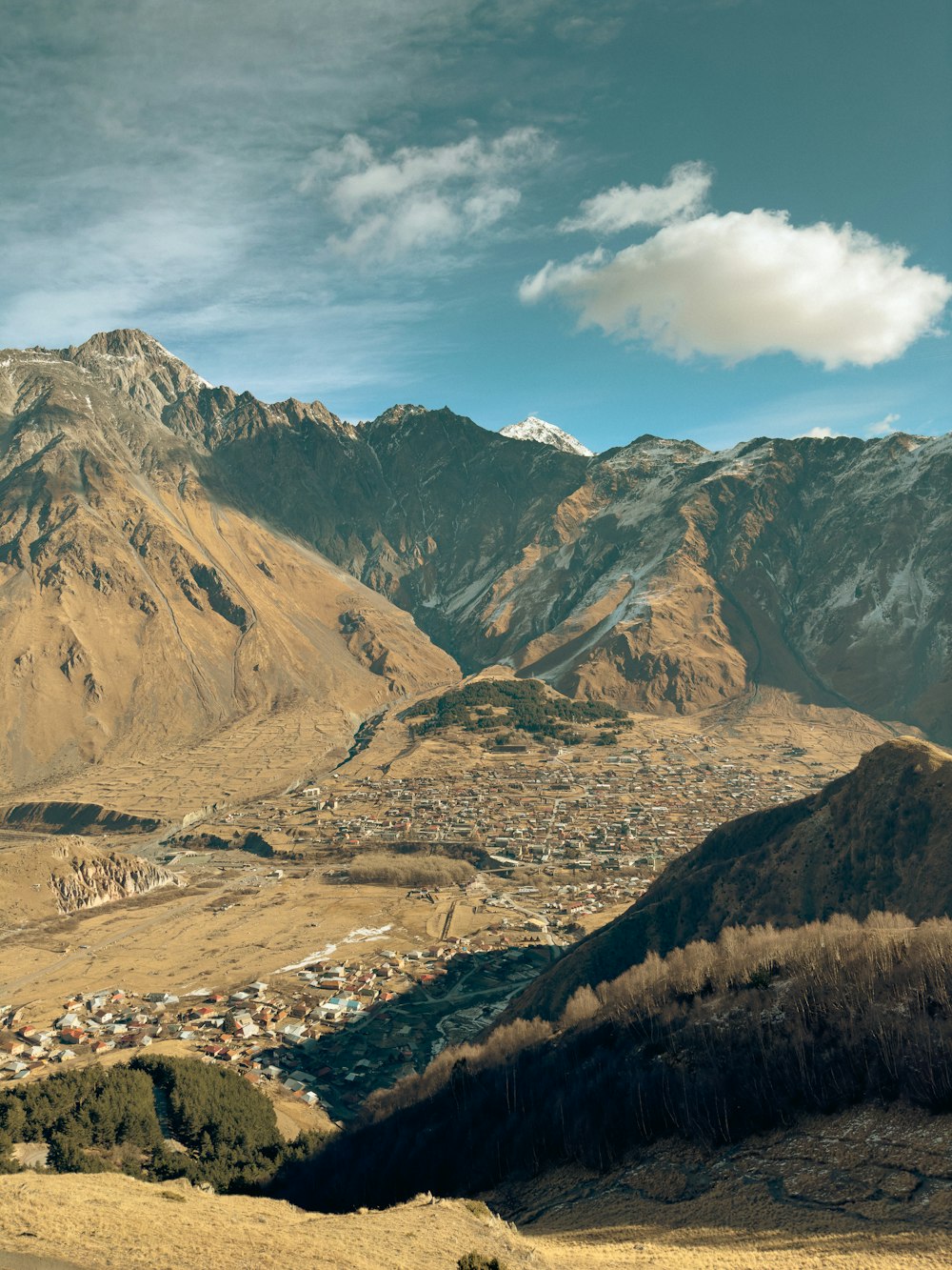 a view of a town in the mountains