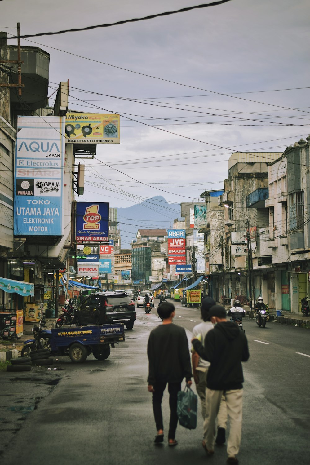 a couple of people walking down a street