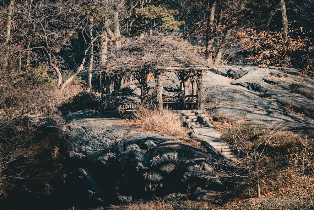 a gazebo sitting on top of a large rock