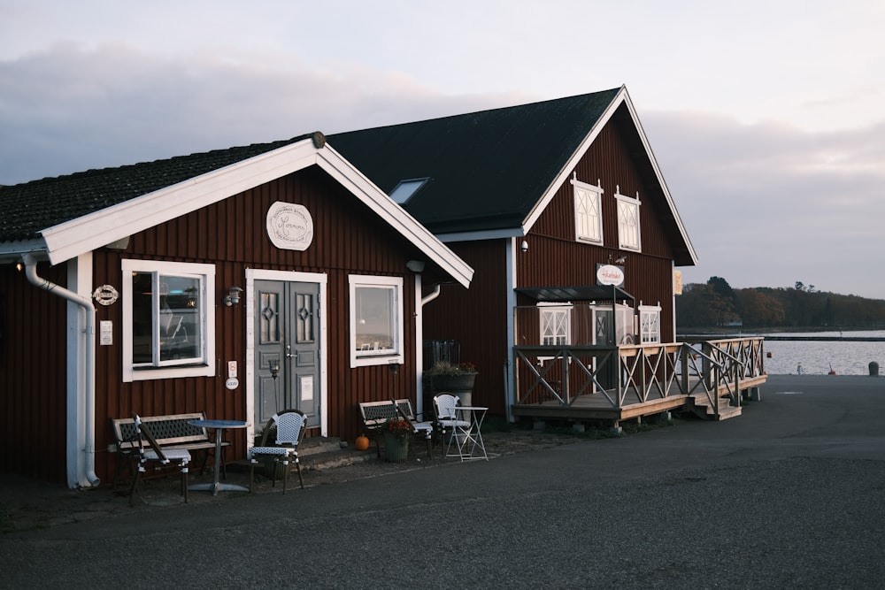 a brown house with a porch and a boat dock