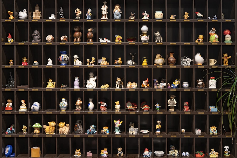 a shelf filled with lots of different types of figurines