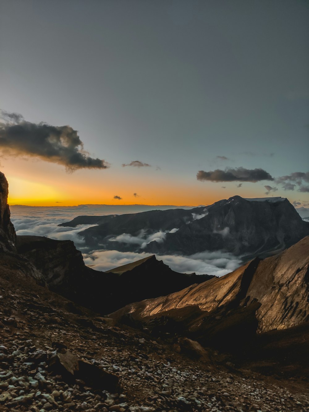 a person standing on top of a mountain at sunset