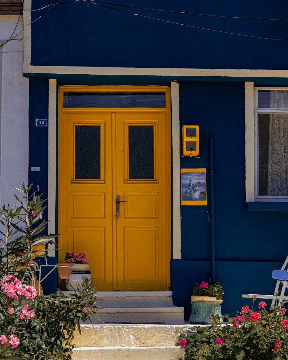 a blue and yellow house with a yellow door