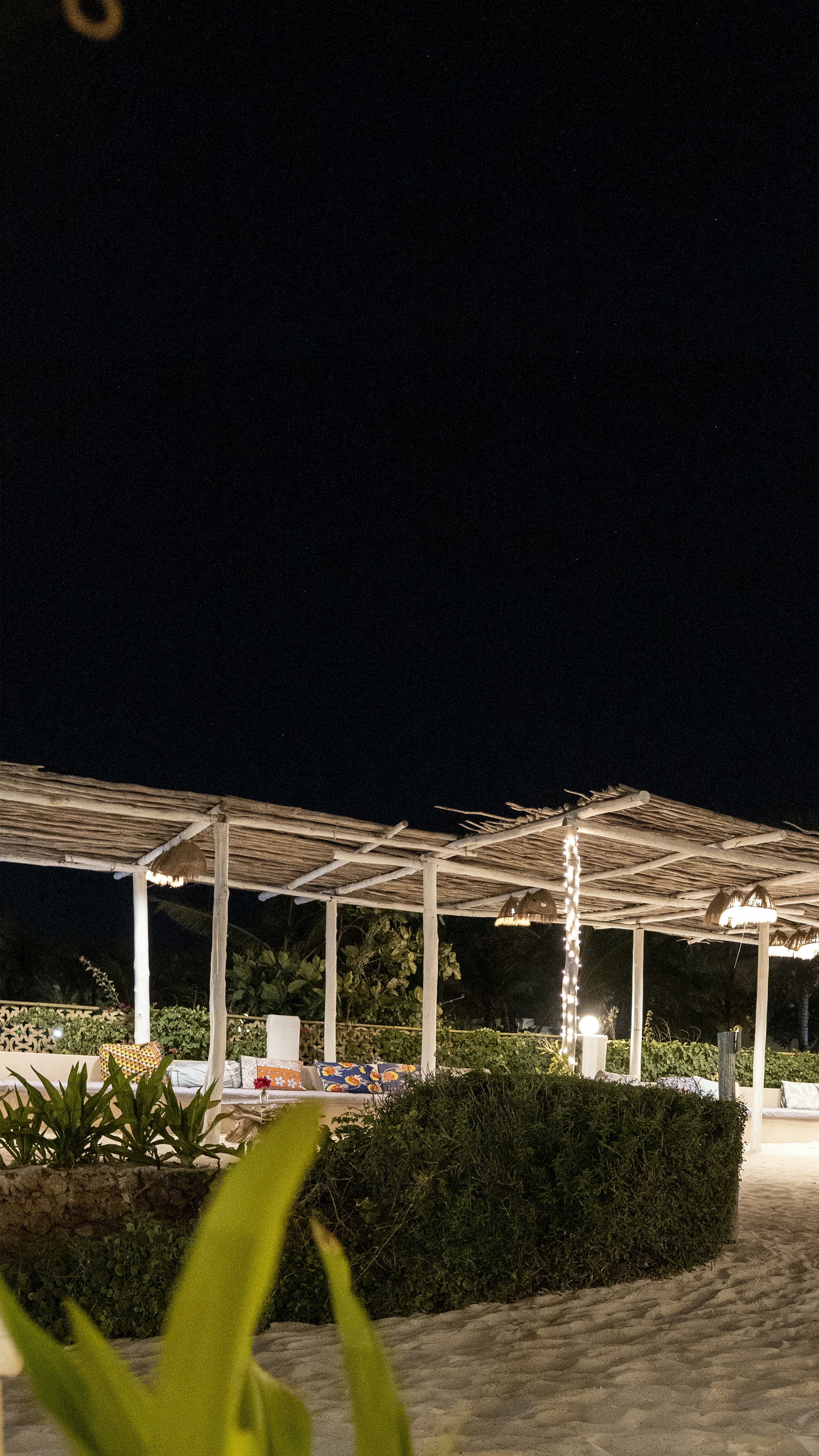 a couple of umbrellas sitting on top of a sandy beach