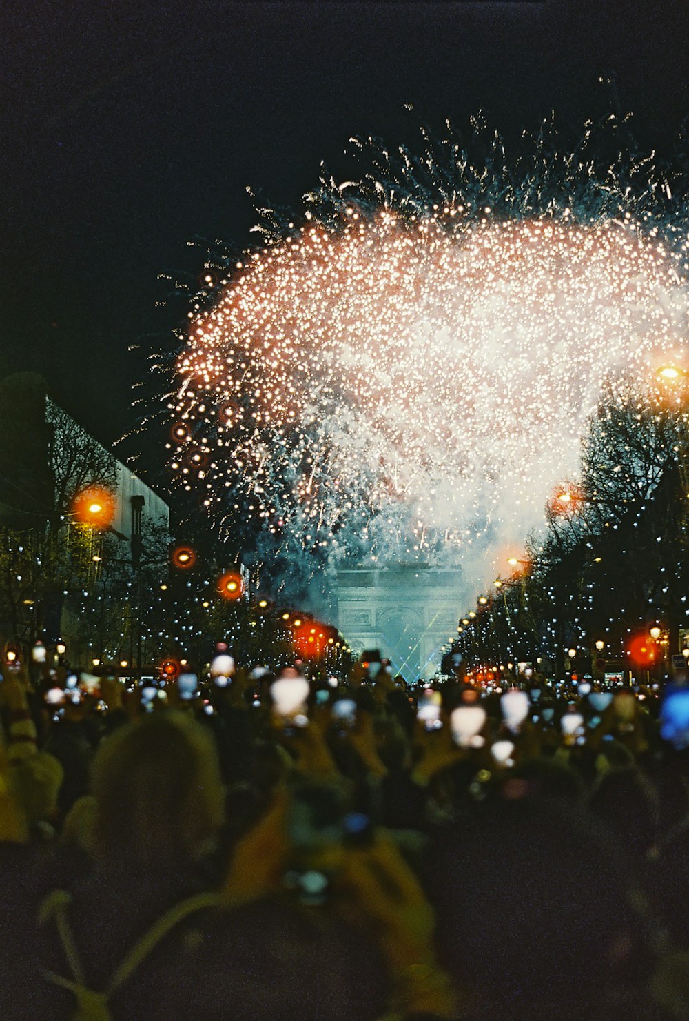 a crowd of people watching a fireworks display