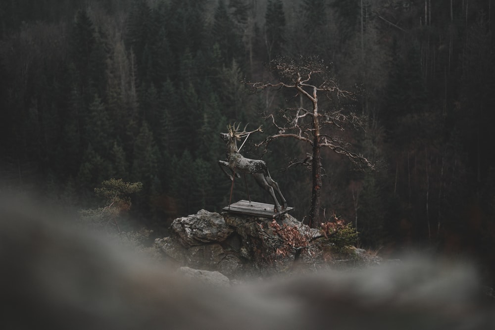 a statue of a deer on top of a rock
