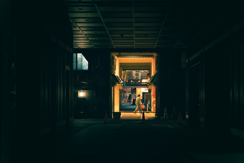 a person walking out of a building at night