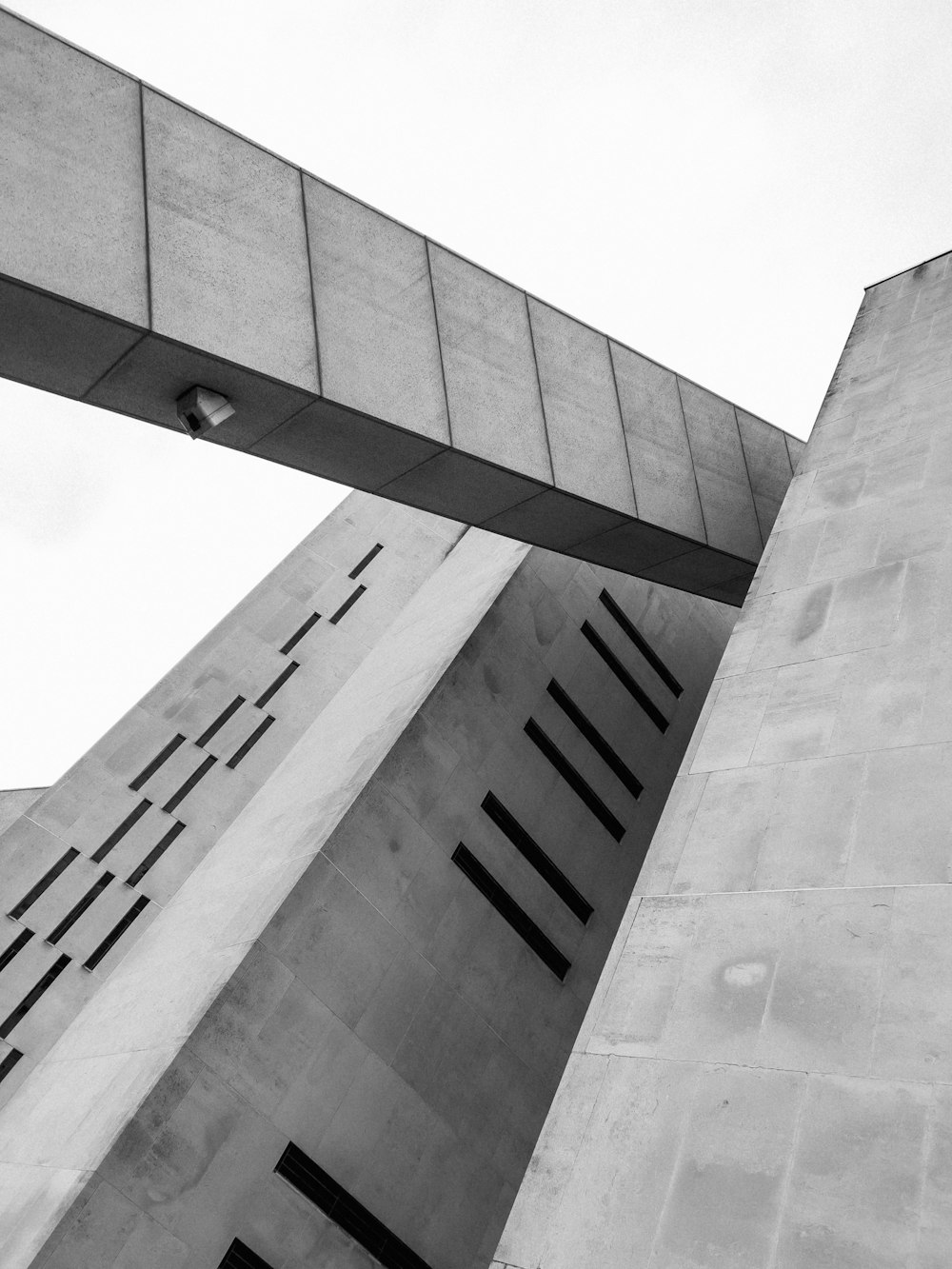 a black and white photo of two tall buildings