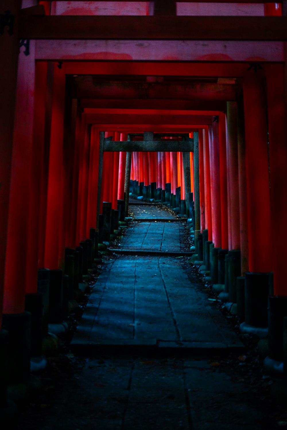 a walkway lined with red columns and lights