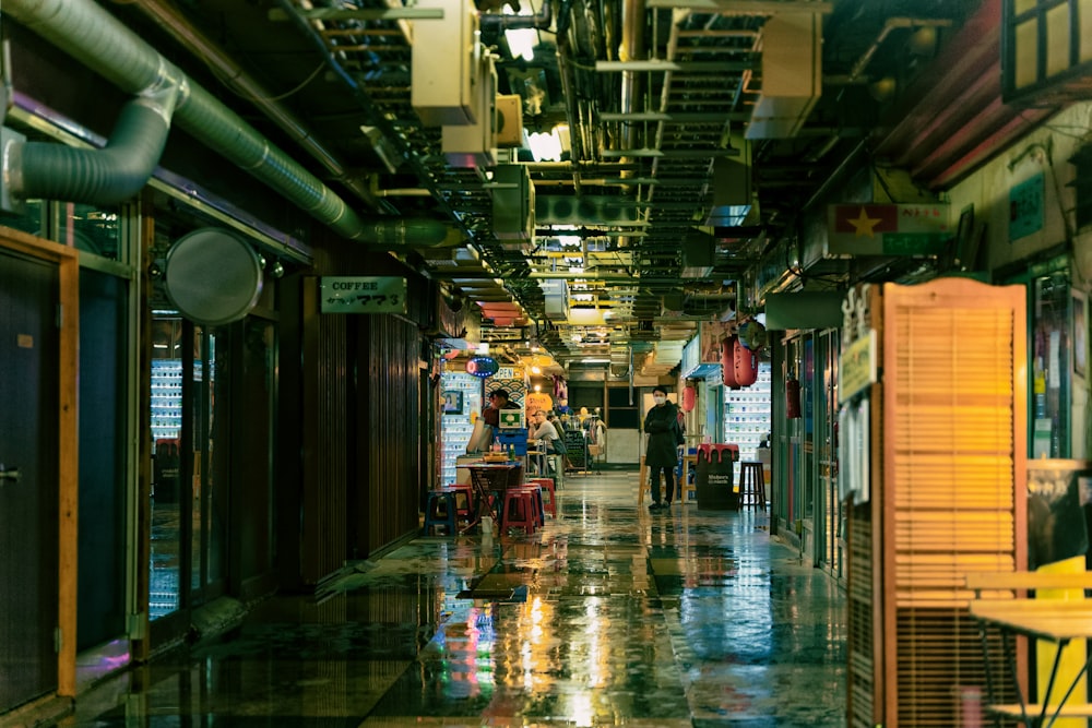 a long hallway with people walking down it