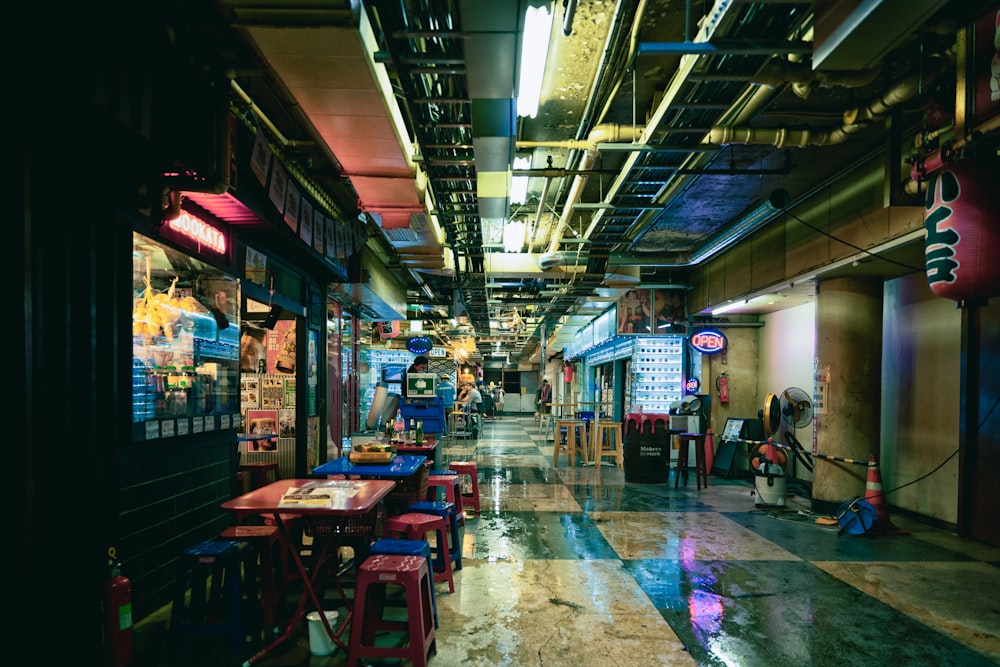 a long hallway with tables and chairs in it