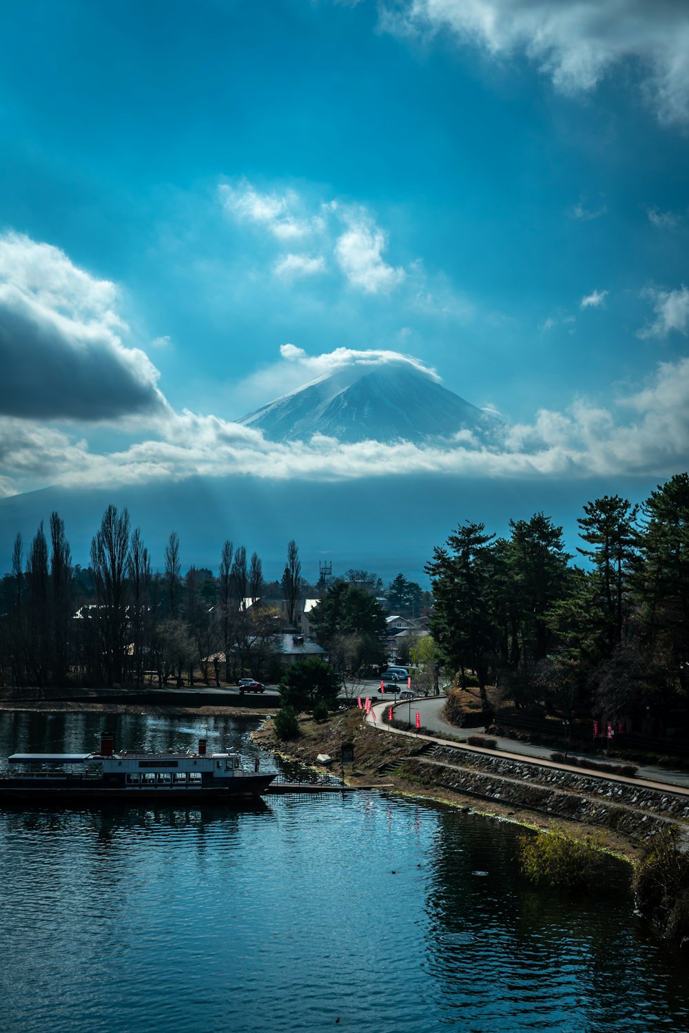 a large body of water with a mountain in the background