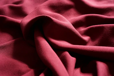 Rich karandi fabric draped gracefully, showcasing its softness and depth.