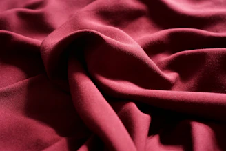 Rich karandi fabric draped gracefully, showcasing its softness and depth.