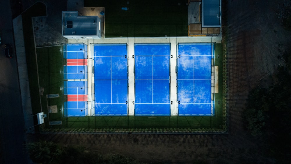 an aerial view of a tennis court at night