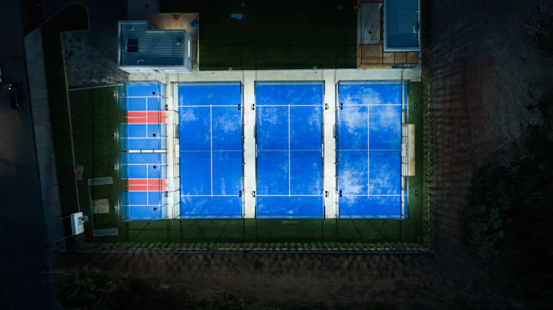 An aerial view of a tennis court at night