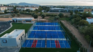 an aerial view of a tennis court in a residential area