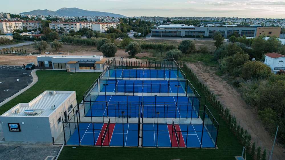 an aerial view of a tennis court in a residential area
