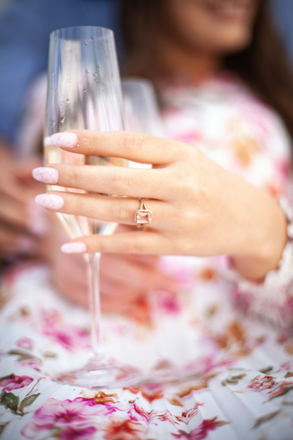 a close up of a person holding a wine glass