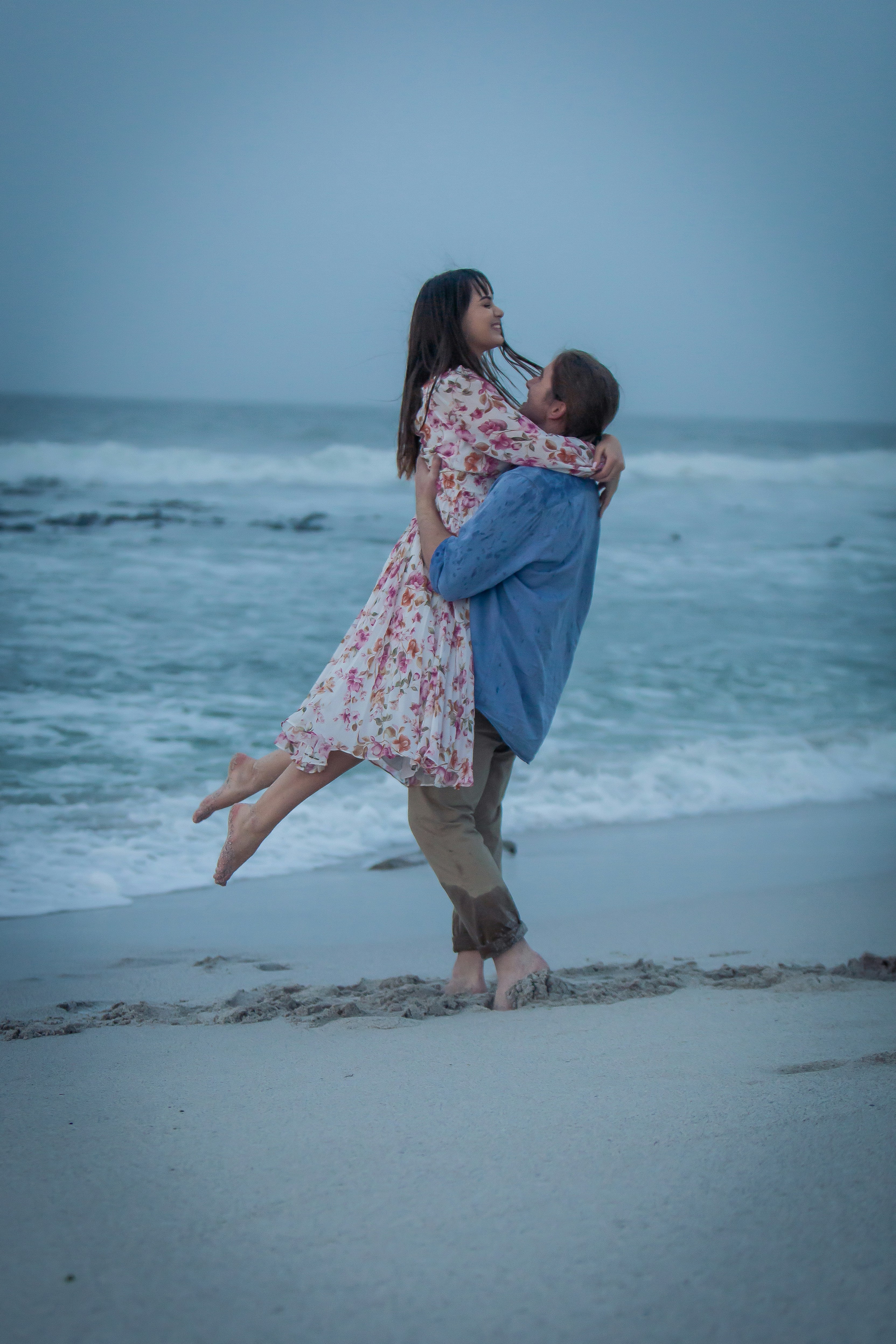 a couple of people that are standing in the sand