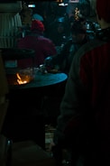 A family enjoying an outdoor gathering near a stove.