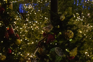 A beautifully decorated Christmas tree with twinkling lights and festive ornaments in the background.