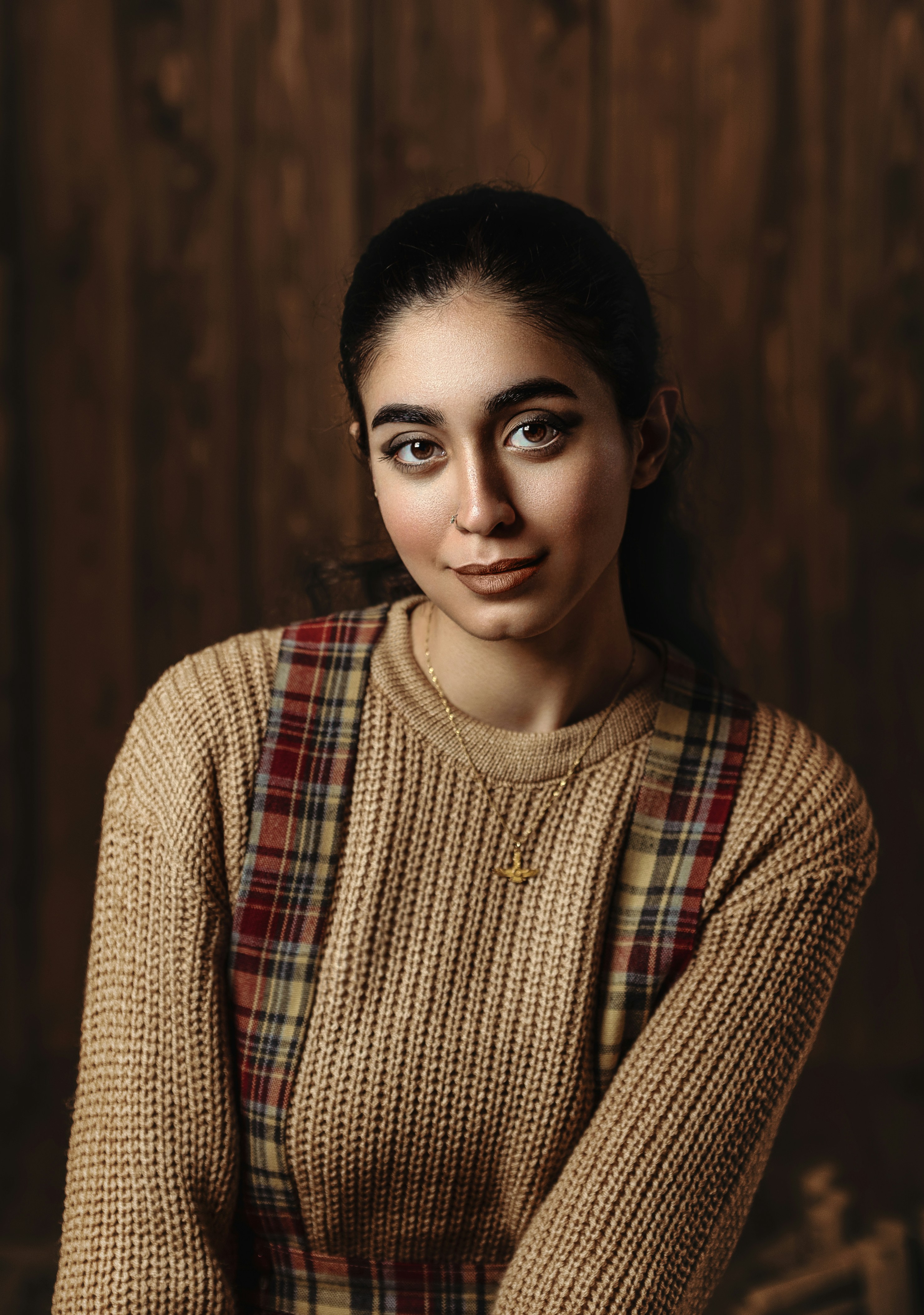 A woman in a sweater posing for a picture