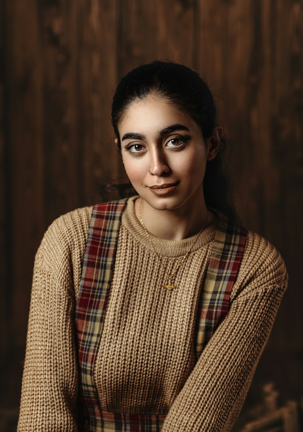 a woman in a sweater posing for a picture