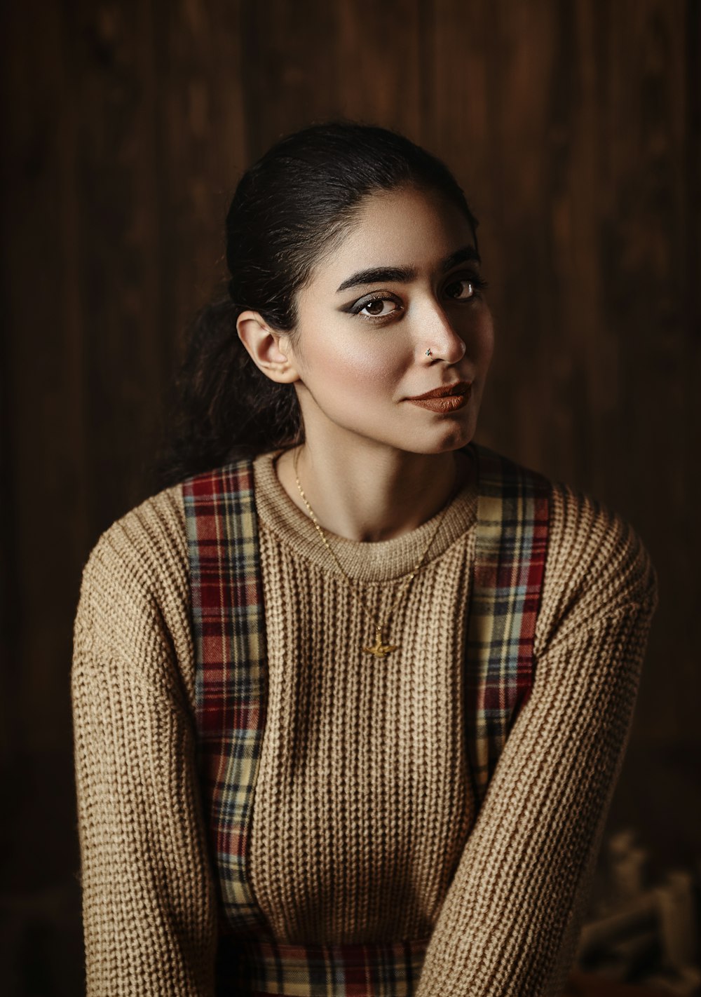 a woman in a sweater is posing for a picture