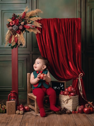 A smiling child holding a fresh apple received from the pantry