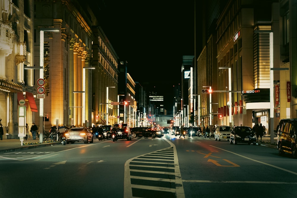 a city street at night filled with traffic