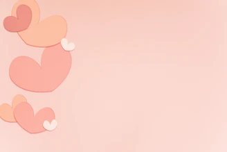 Soft pink floral background with subtle gold accents and gently falling animated heart petals.