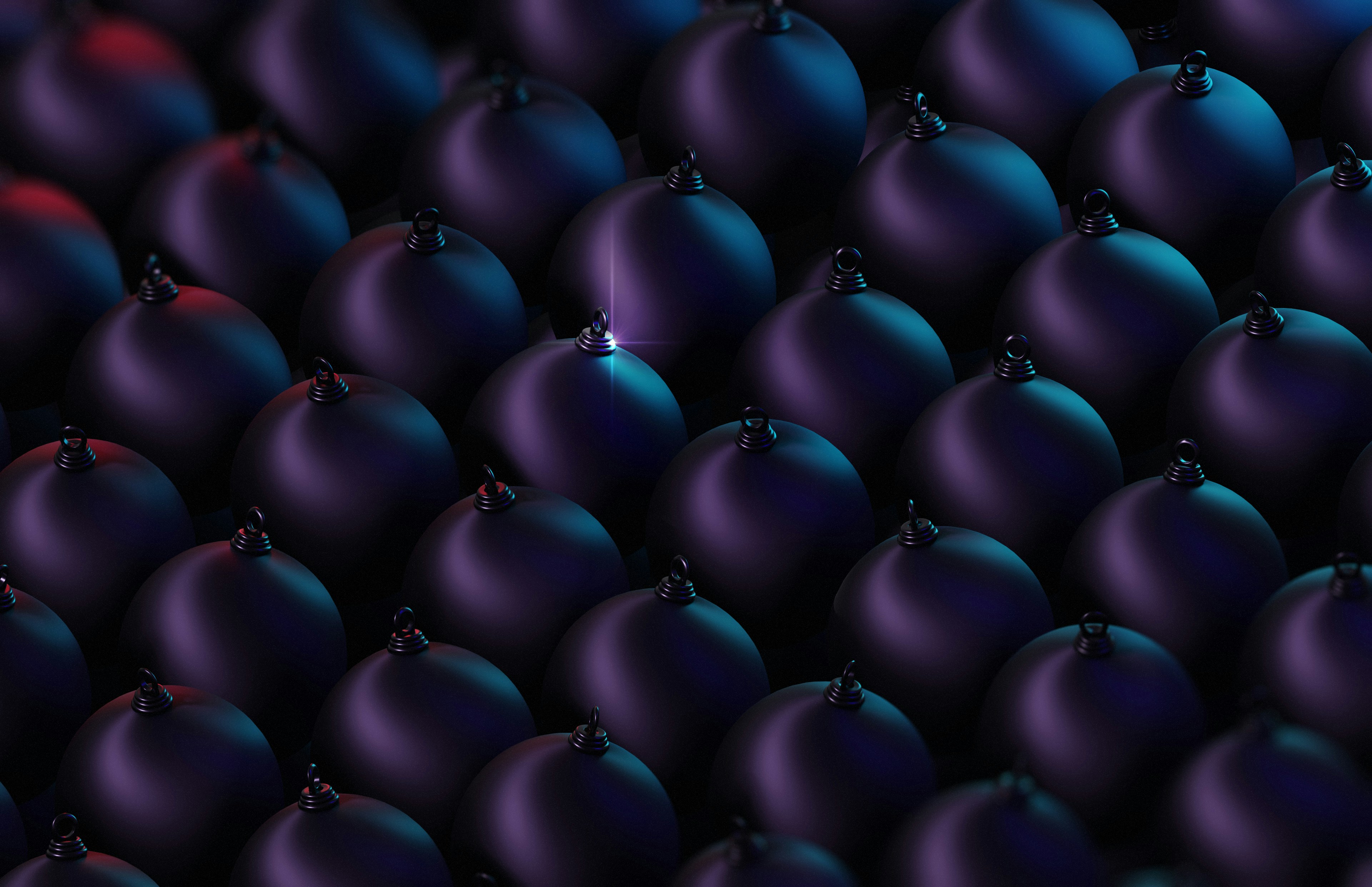 a group of black balls with a red light in the middle