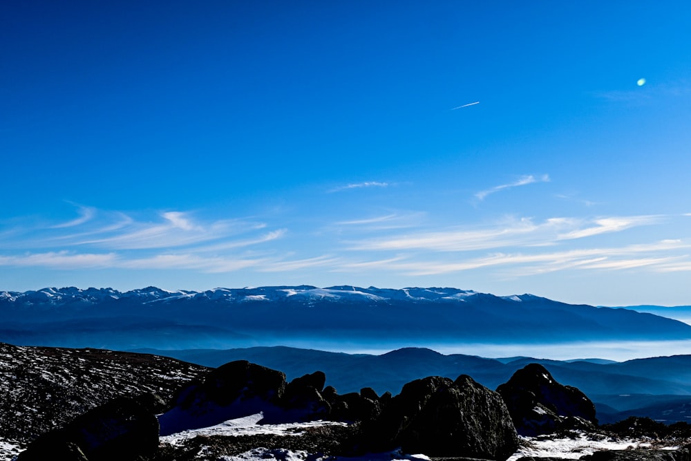 a person standing on top of a snow covered mountain