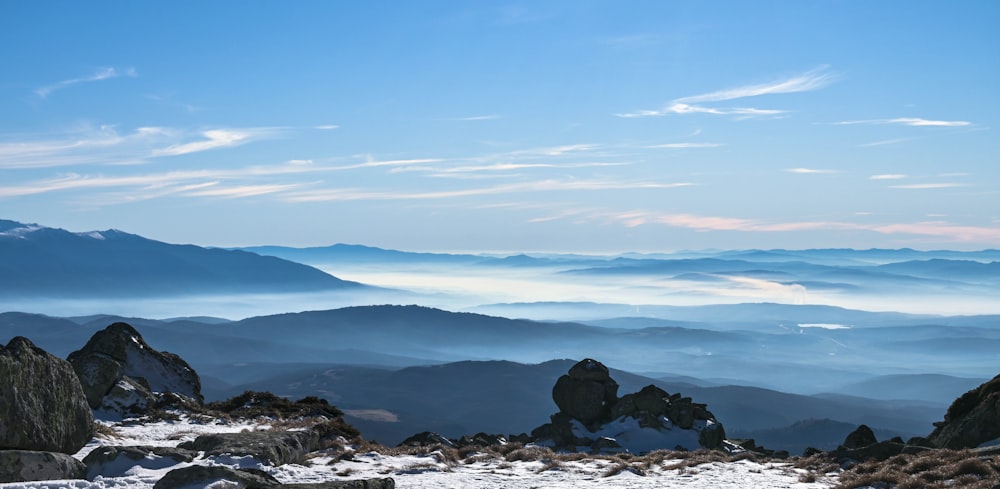 a view of a mountain range with snow on the ground