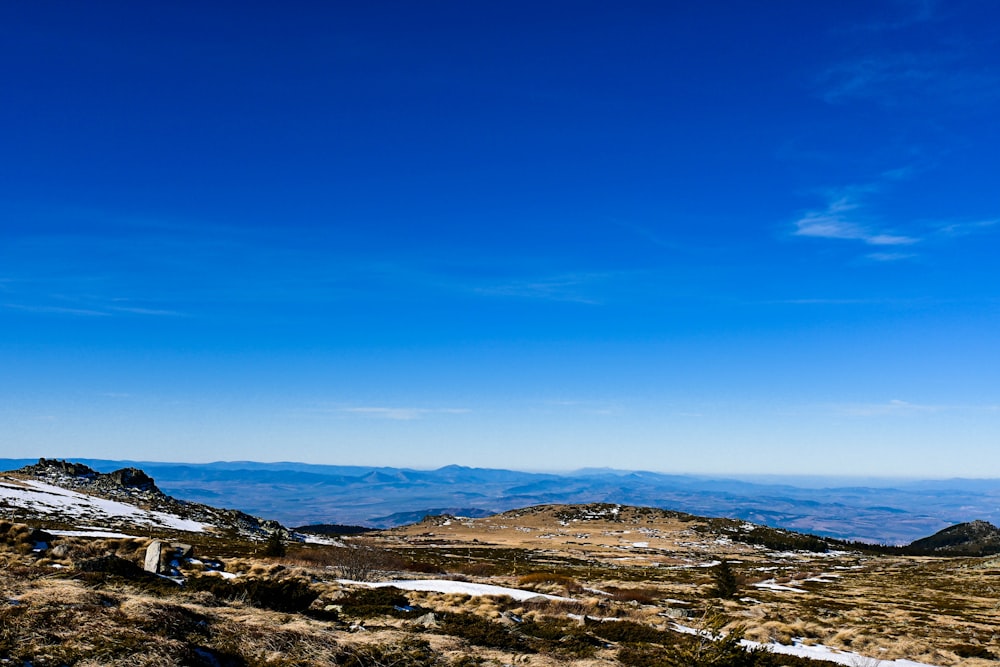 a view of a mountain range with snow on the ground