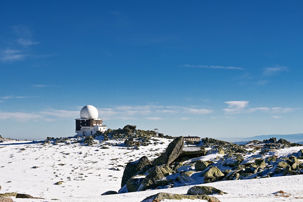 a satellite dish on top of a snowy hill