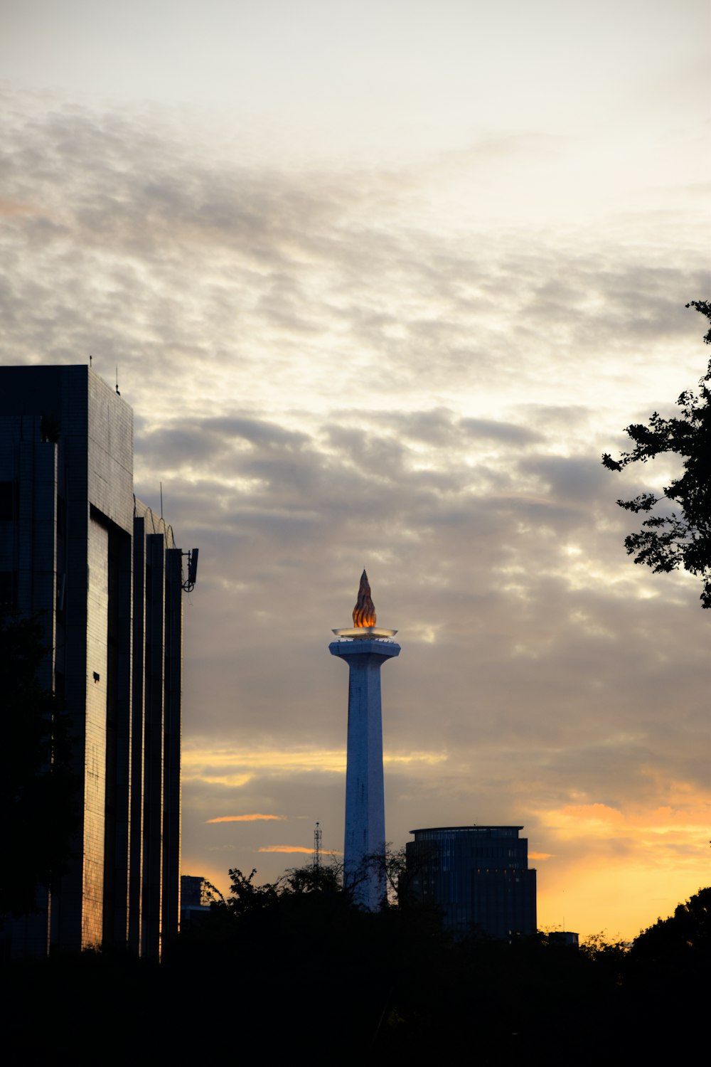 a tall tower with a spire in the middle of a city