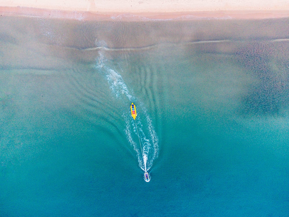 an aerial view of a boat in the ocean