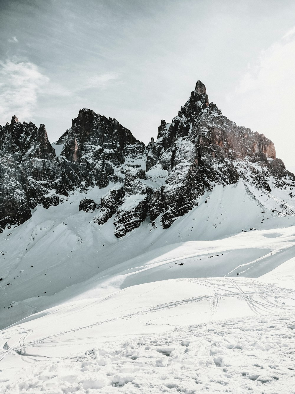 a man riding skis on top of a snow covered slope