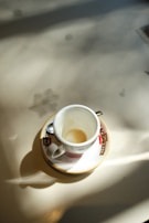 A sunlit terrace with empty chairs and a single coffee cup, evoking quiet moments.