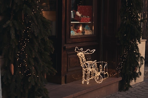 A festive business storefront adorned with Christmas decorations.